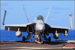 A Boeing F/A-18C Hornet sits on the back of the USS Abraham Lincoln (CVN-72) Aircraft Carrier as the waves from heavy swells rock the ship back and forth. - Photo by Britt Dietz A Boeing F/A-18C Hornet sits on the back of the USS Abraham Lincoln (CVN-72) Aircraft Carrier as the waves from heavy swells rock the ship back and forth. - Photo by Britt Dietz